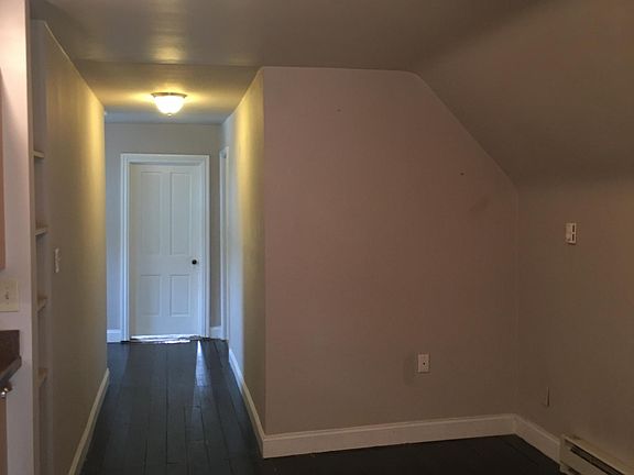 dining area next to kitchen with high ceiling cut out