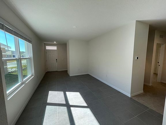 Open foyer and dining room/multi-purpose room (includes smart home air condition thermostat and front-door smart lock)