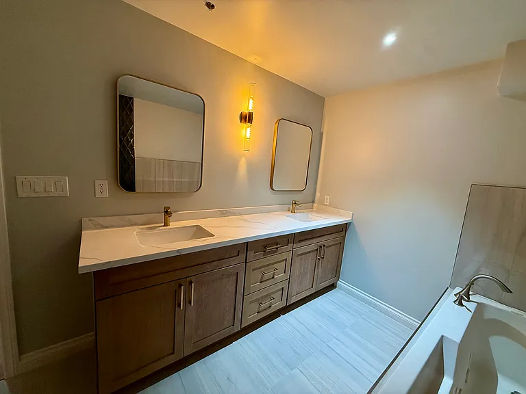 Master bathroom vanities with oak cabinets and quartz
