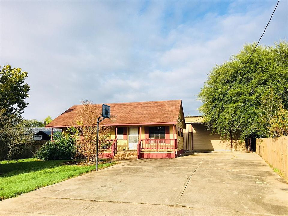 Front of home with fully paved parking area including inside the garage!