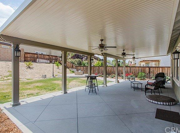 An oversized alumawood patio cover provides an excellent entertaining location, complete with 3 ceil