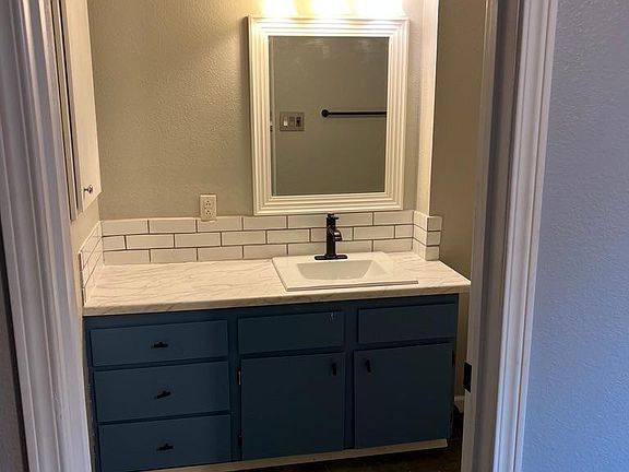 Fresh backsplash, new sink, fixtures, counters and faucet, fresh paint on vanity. The floors are new tile