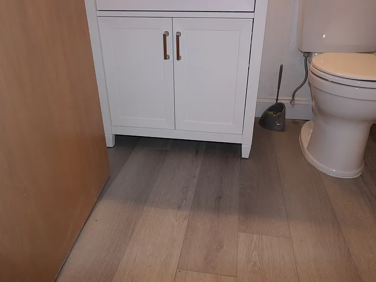 New luxury vinyl flooring installed in bathroom.