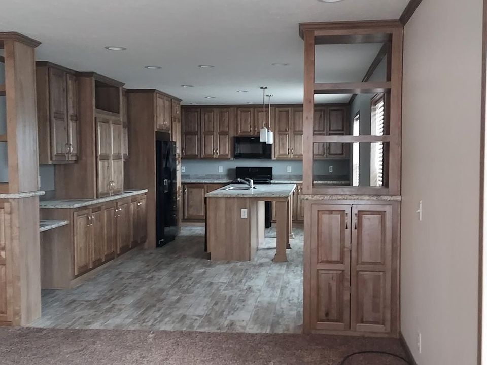 Phenomenal kitchen with tons of storage! Built in pantry and workdesk area. Island can seat 4-6. Tile backsplash.