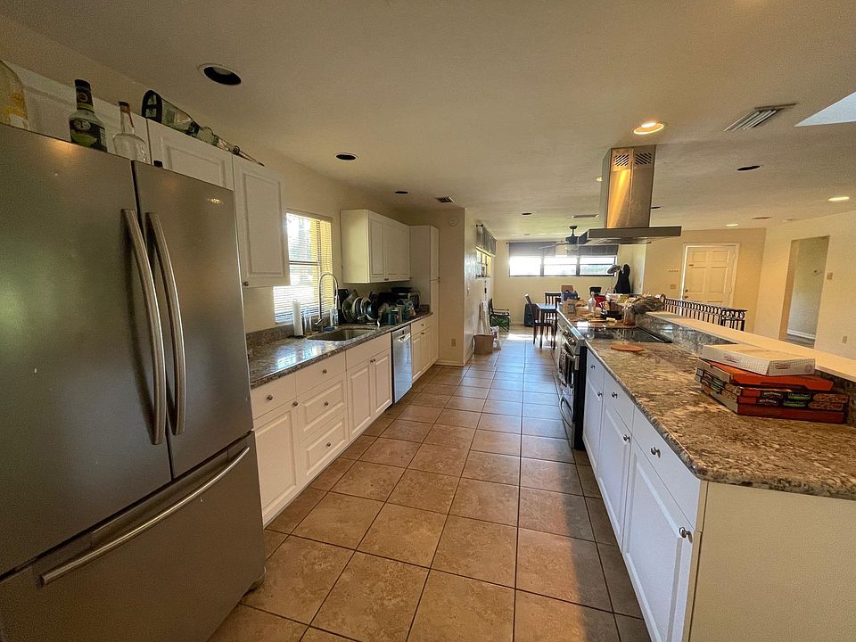 open concept kitchen with granite counters and stainless steel appliances
