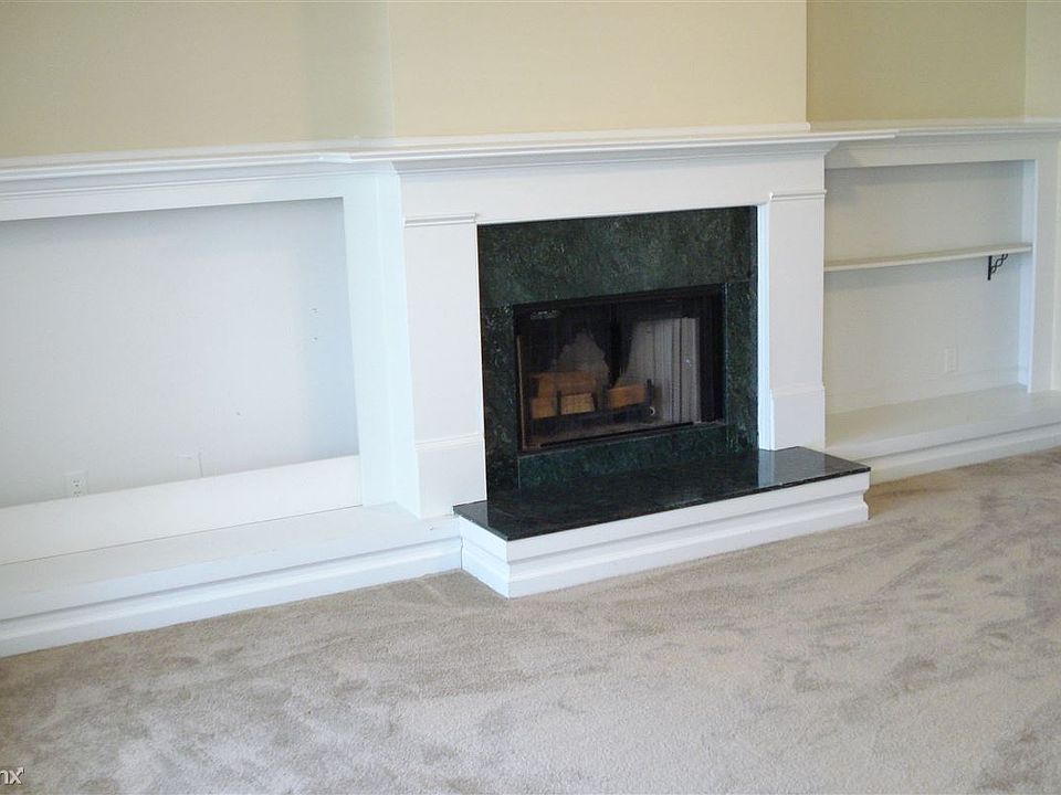 a real wood burning fireplace in formal living with vaulted