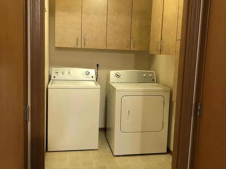 washer dryer utility room with lots of shelves
