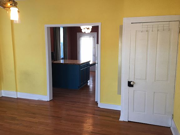 View from living room to kitchen, also basement door
