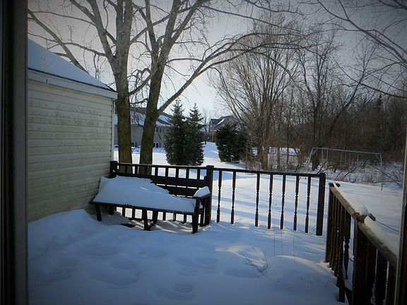 Deck overlooks large backyrd