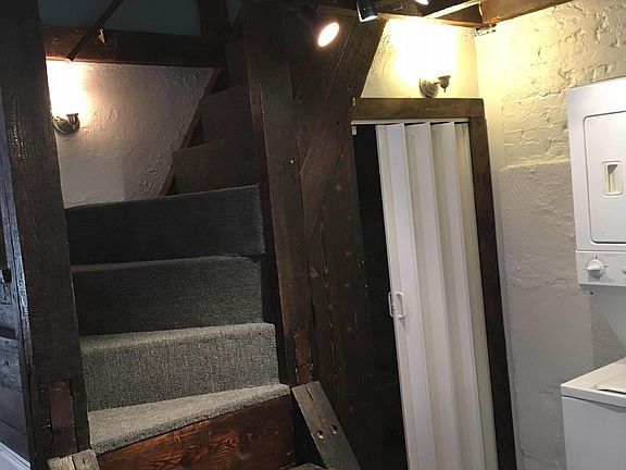 Stairs leading to loft and upstairs bedroom from the kitchen.