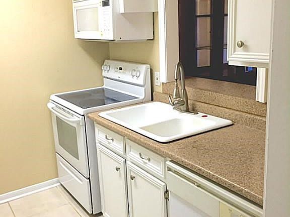 Updated Kitchen has a Breakfast Bar Looking into Dining Room.