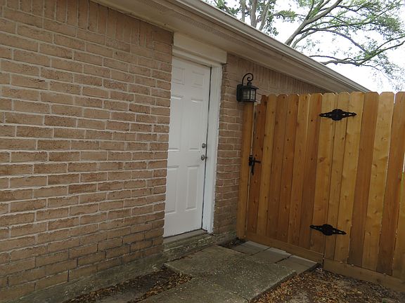 Right hand side of home, providing sidwalks and side entryway into the garge area.