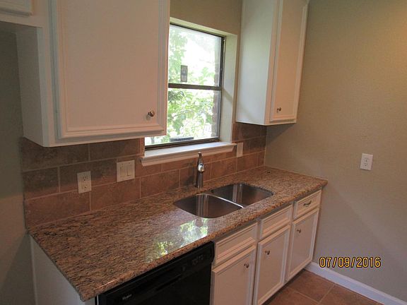 Kitchen Sink with Granite Counters tops and nice backsplash