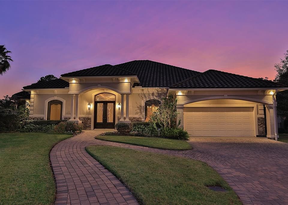 CUSTOM ONE STORY BUILT BY FLAIR CUSTOM HOMES - Nestled in the coveted gated lake community is this architectural gem with open floor plan, panoramic views of two lakes and three car tandem garage.