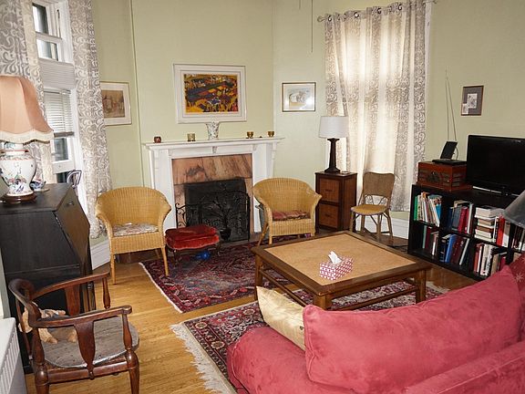 Graciously sized living room with fireplace and curved walls. Huge south-facing windows, lots of sunlight.