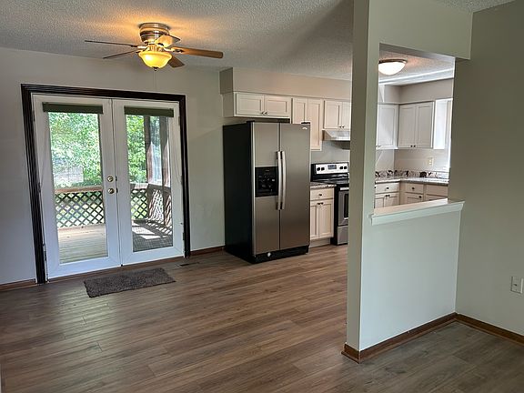 The kitchen and screened porch as seen from the living room...