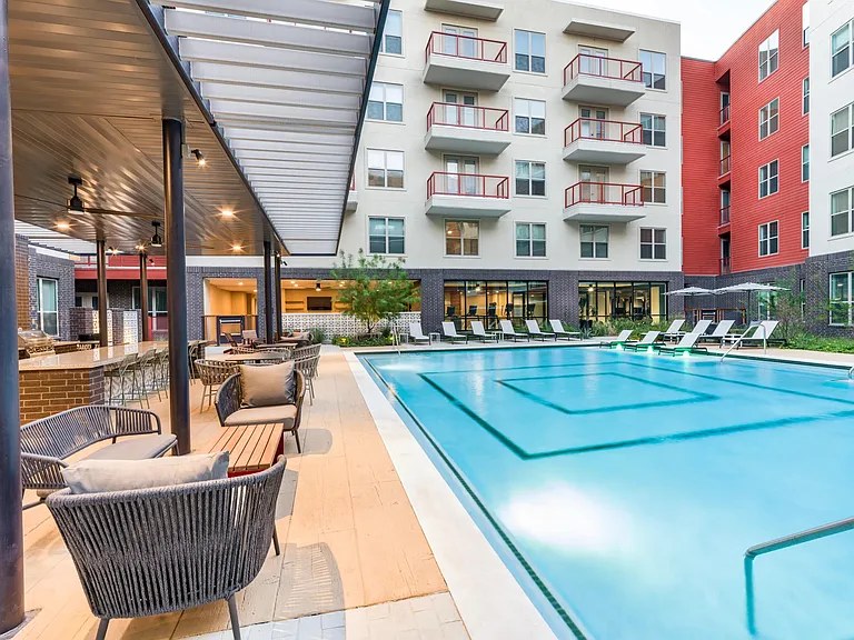 Relax in our resort-style pool, complete with a spacious sunledge and tranquil water features at Modera EaDo.