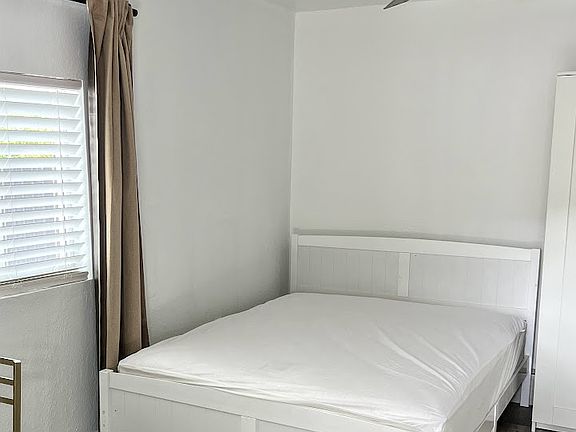 Queen Bed and large windw with blinds and curtains for privacy
