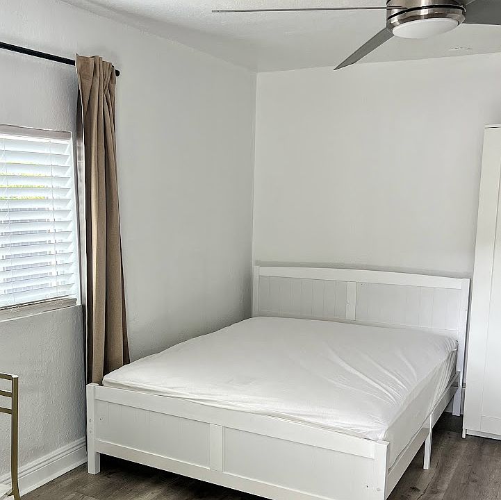 Queen Bed and large windw with blinds and curtains for privacy