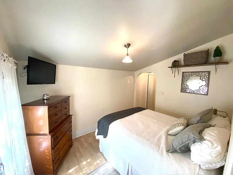 Bedroom 1: Archway leads to closet and bathroom