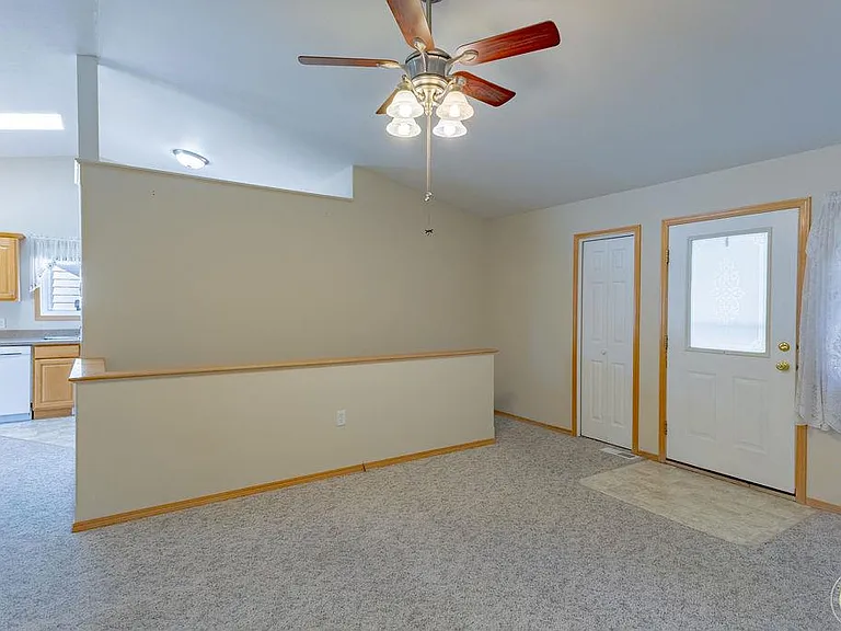 New flooring is being installed this well. Un-staged living room, stairway to 2nd and 3rd egress bedrooms