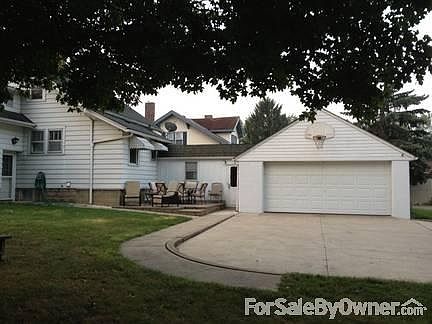 Rear of House
						:
						2 Car garage attached w/patio and very large paved area for additional cars
