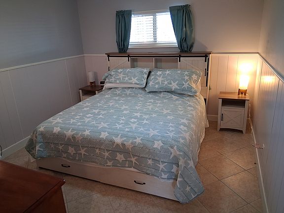 Master bedroom, dresser, and tv.
