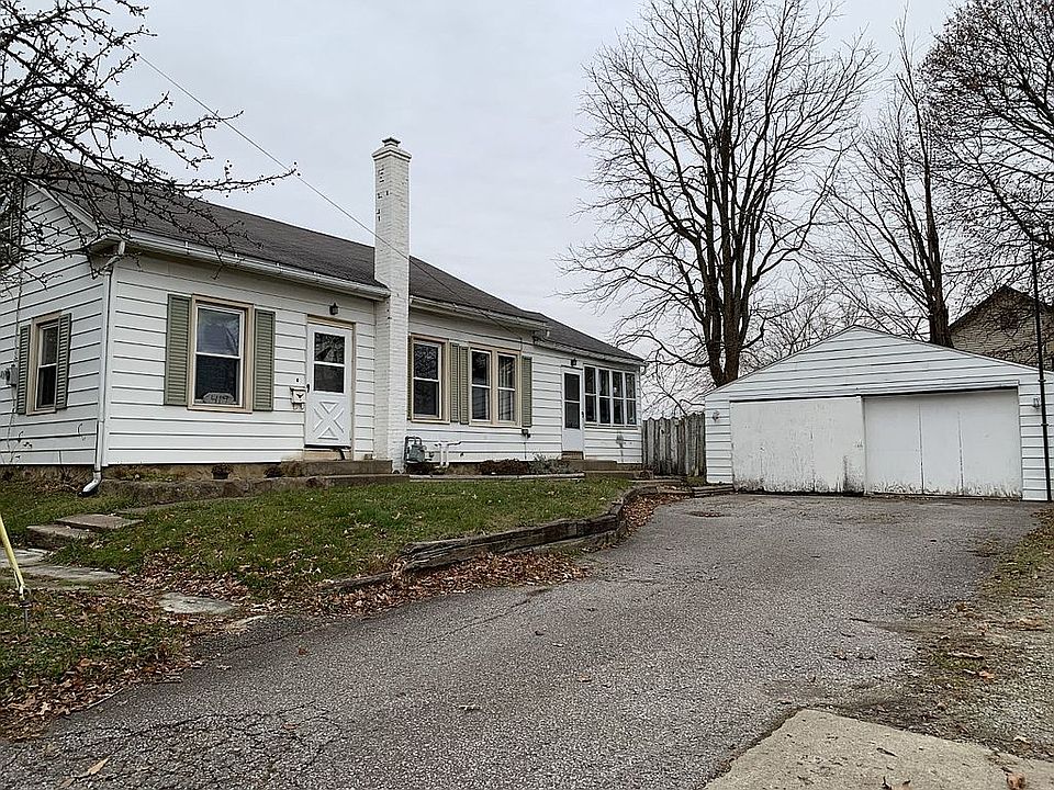 House faces detached garage.