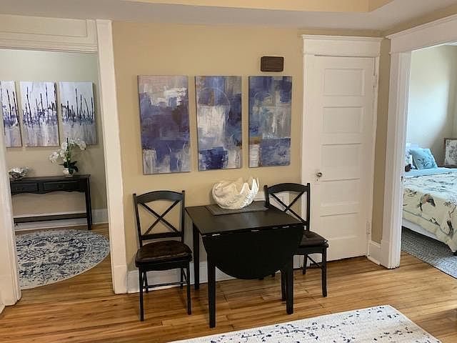 Living room with taupe walls and furnishings - looking into foyer. Furnishings not included!