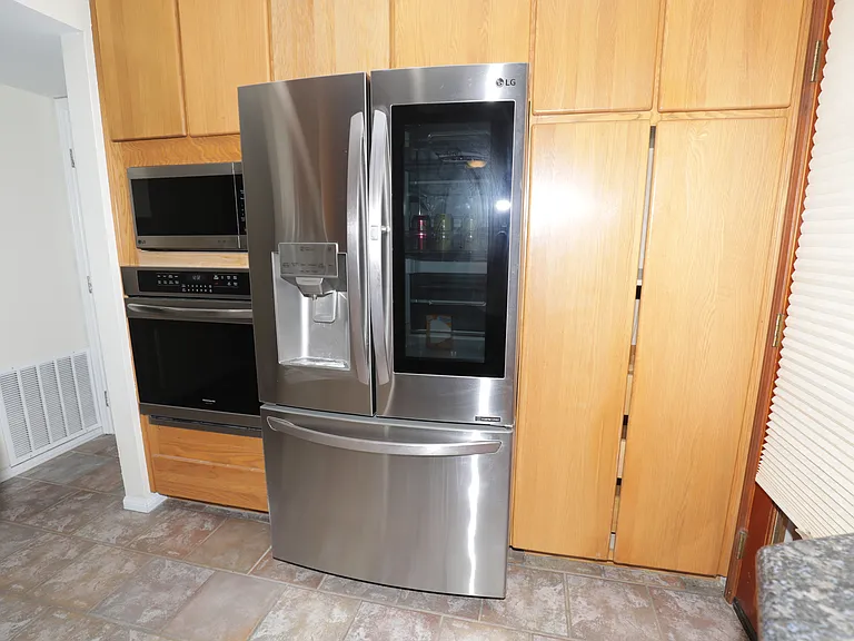 Modern refrigerator, in-wall oven and microwave