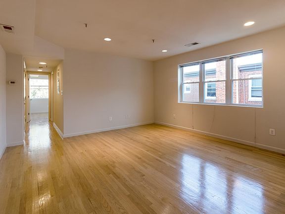 Vacant den looking into bedroom. Great light!