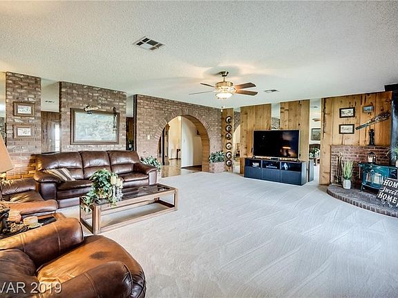 Family Room with Brick Accent Wall and New Carpet.