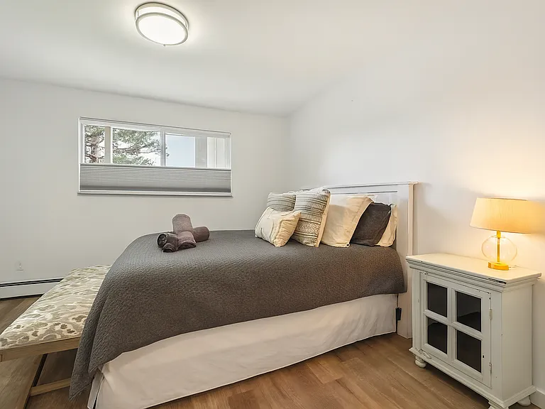 Relax in a comfy queen bed and wake up to serene mountain views through the window.