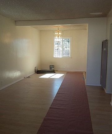 Laminate floors throughout,  Dining and Living rooms are connected,  and Kitchen w/Dining room
