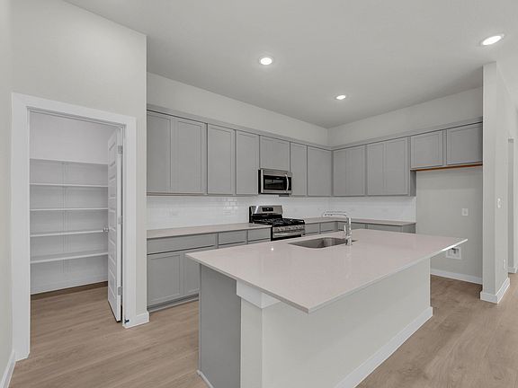 Kitchen in the Pecos home plan by Trophy Signature Homes - REPRESENTATIVE PHOTO