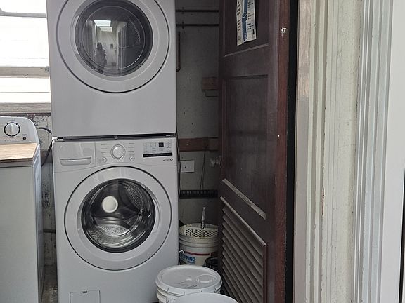 Private laundry machine located outside the front door