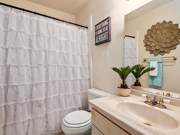 Bedroom 1 En-Suite Bathroom - Tub/Shower Combo and extra strorage space under the sink.