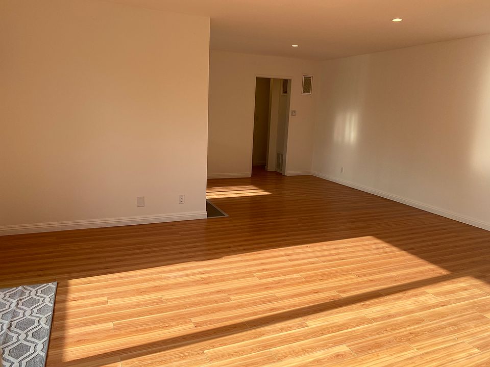 Expansive, bright living room/dining room. Brand-new upgraded vinyl wood flooring not pictured.