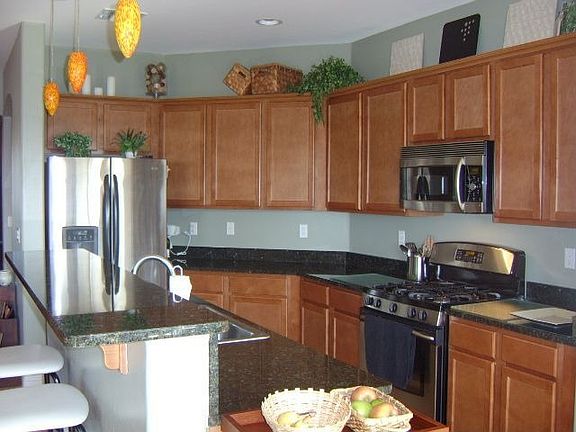 Kitchen with granite counters, stainless steel appliances, 42" maple cabinets