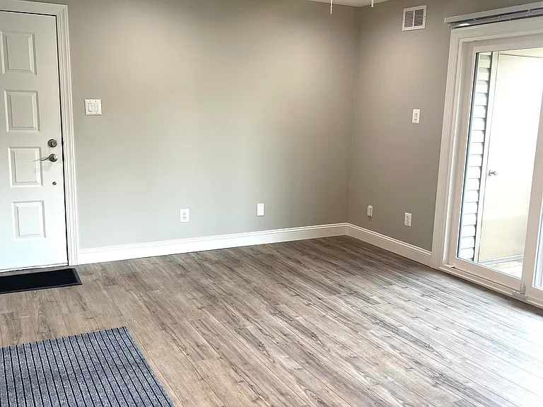 Living with with slidding pation door to balcony and storage closet