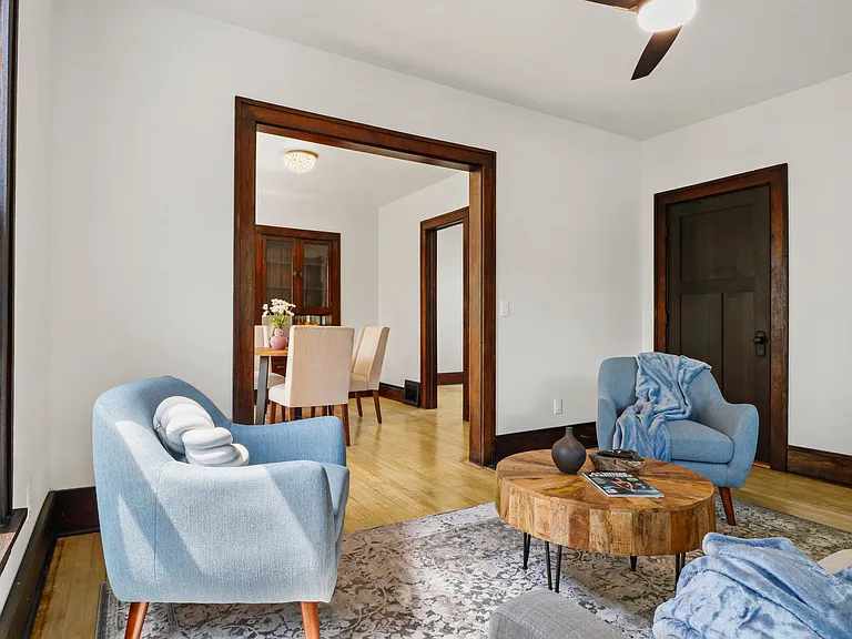 This photo shows the living area connecting into the dinign area. Notice the beautiful hard woods!