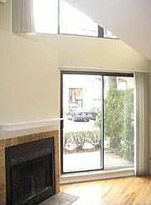Downstairs fireplace/sliding door entrance to patio