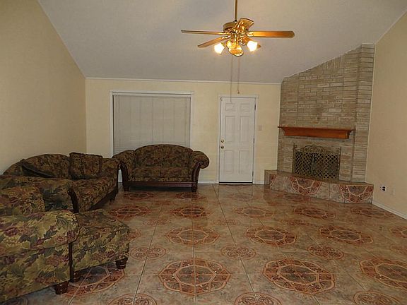 Living room (19x18) has high ceiling with beam. Ceiling fan & corner fireplace
