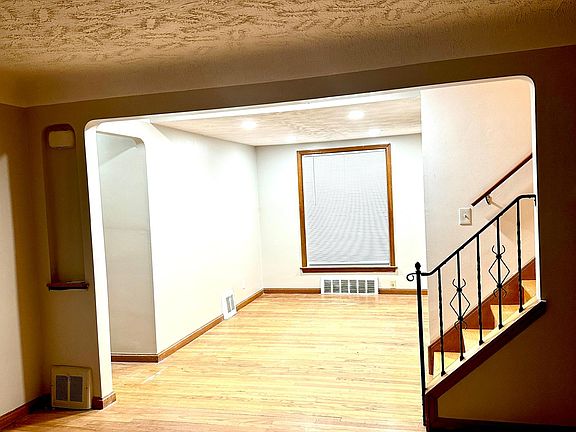Well-lit dining room with recess lighting