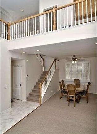 Dramatic entry with 2-story ceiling, looking past corner of livi