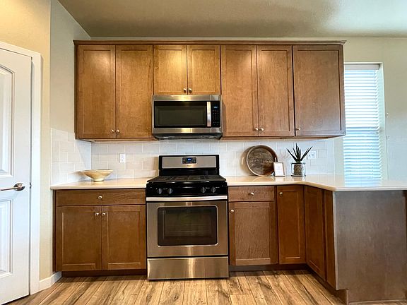 Kitchen with pantry, stainless steel appliances & gas stove