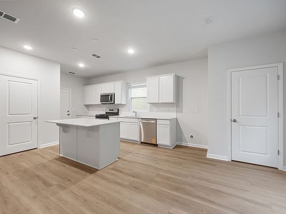 Longspur Kitchen with bright white cabinets.
