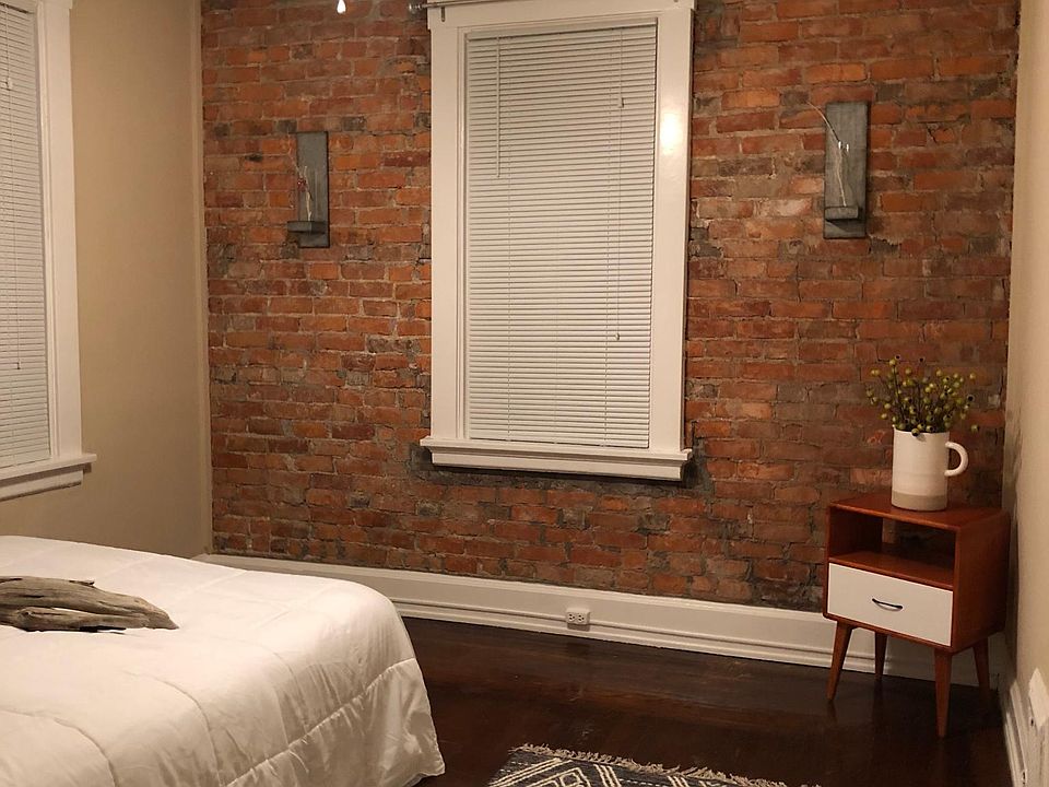 Bedroom with "newly" exposed original brick wall