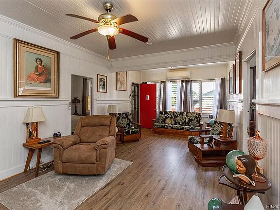 Living area showing entrances to bedrooms: one entrance to left and other bedroom opposite to right.