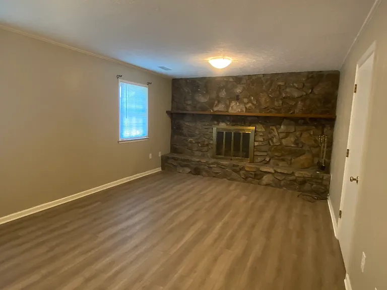 Downstairs family room with stone fireplace